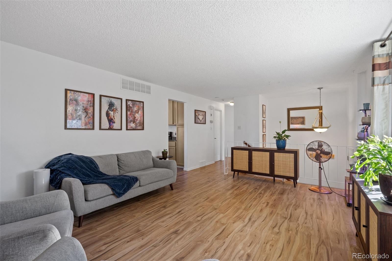 357 Saturn Place Lone Tree, CO 80124 - Photo 13 of 39 a living room with furniture and a wooden floor