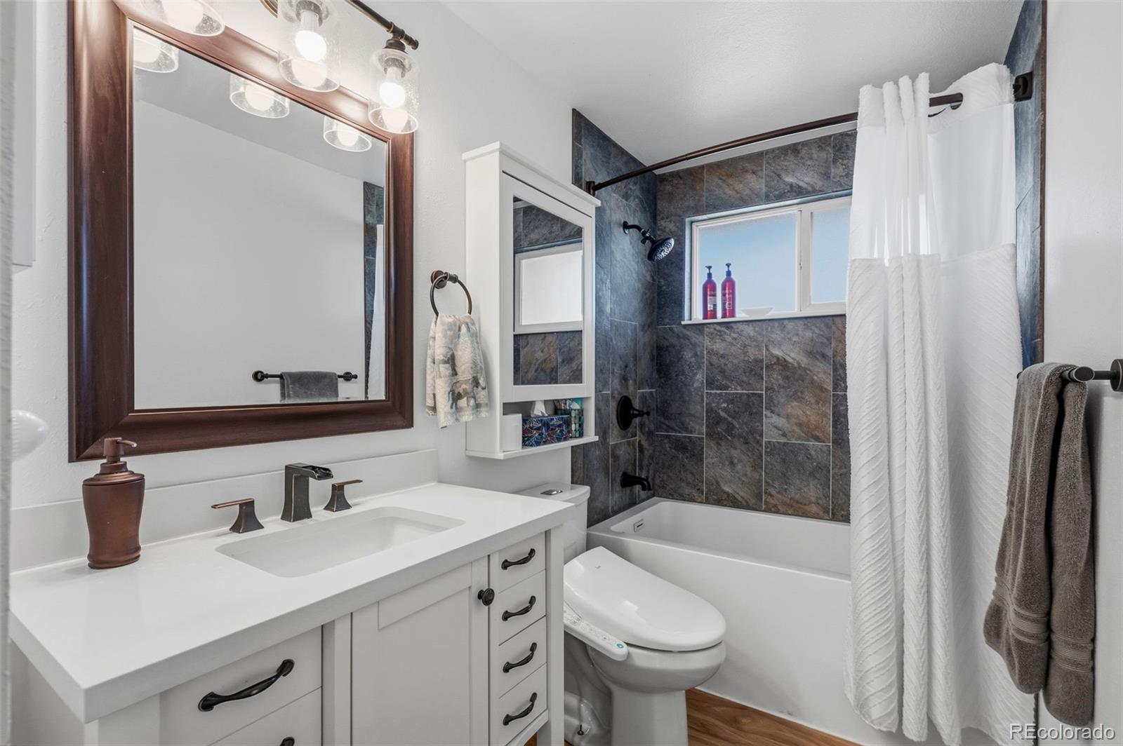 357 Saturn Place Lone Tree, CO 80124 - Photo 14 of 39 a bathroom with a sink toilet tub and shower