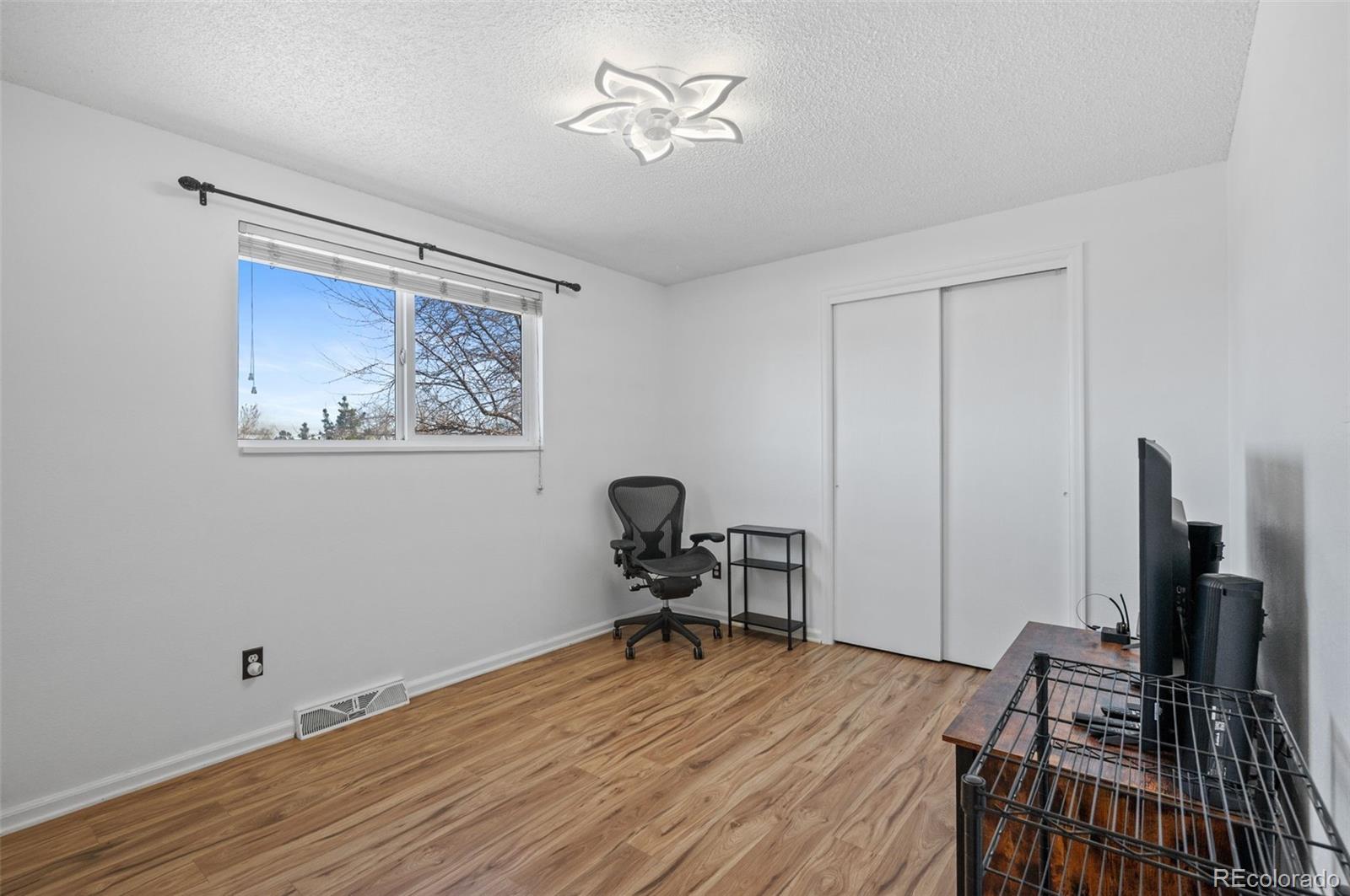 357 Saturn Place Lone Tree, CO 80124 - Photo 17 of 39 a room with furniture and wooden floor
