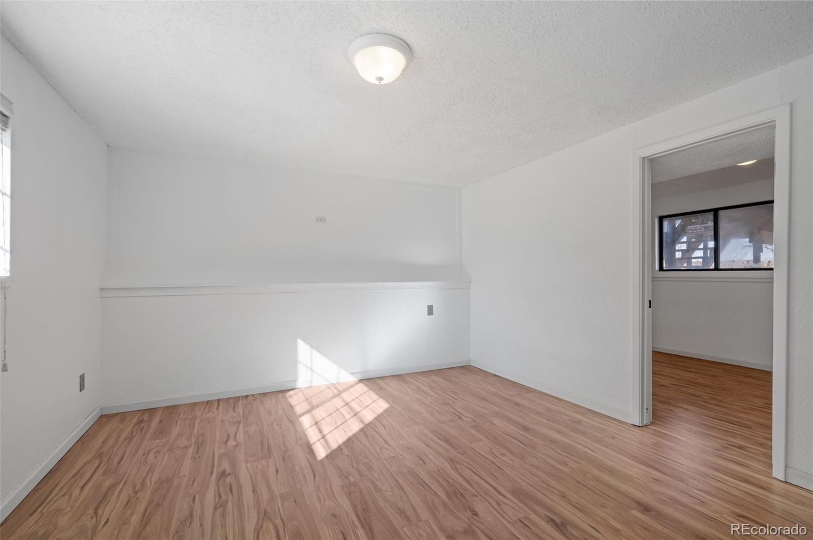 357 Saturn Place Lone Tree, CO 80124 - Photo 19 of 39 wooden floor in an empty room with a window