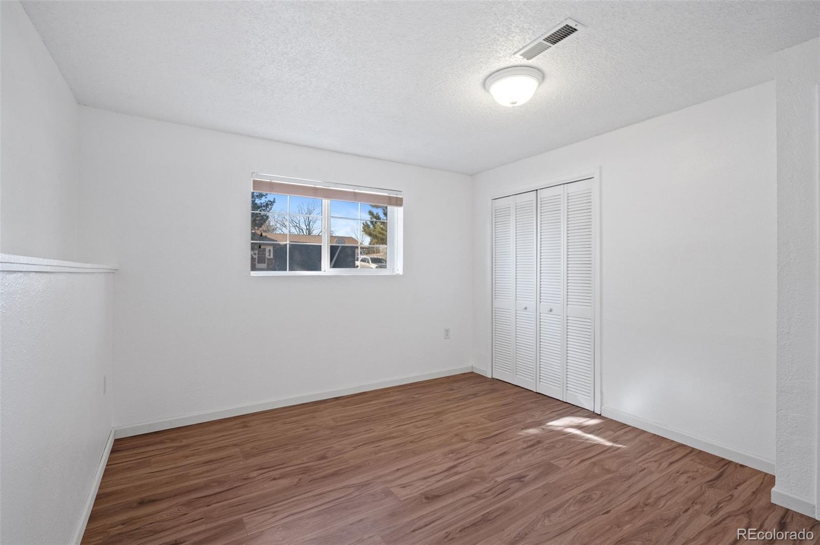 357 Saturn Place Lone Tree, CO 80124 - Photo 21 of 39 wooden floor in an empty room with a window