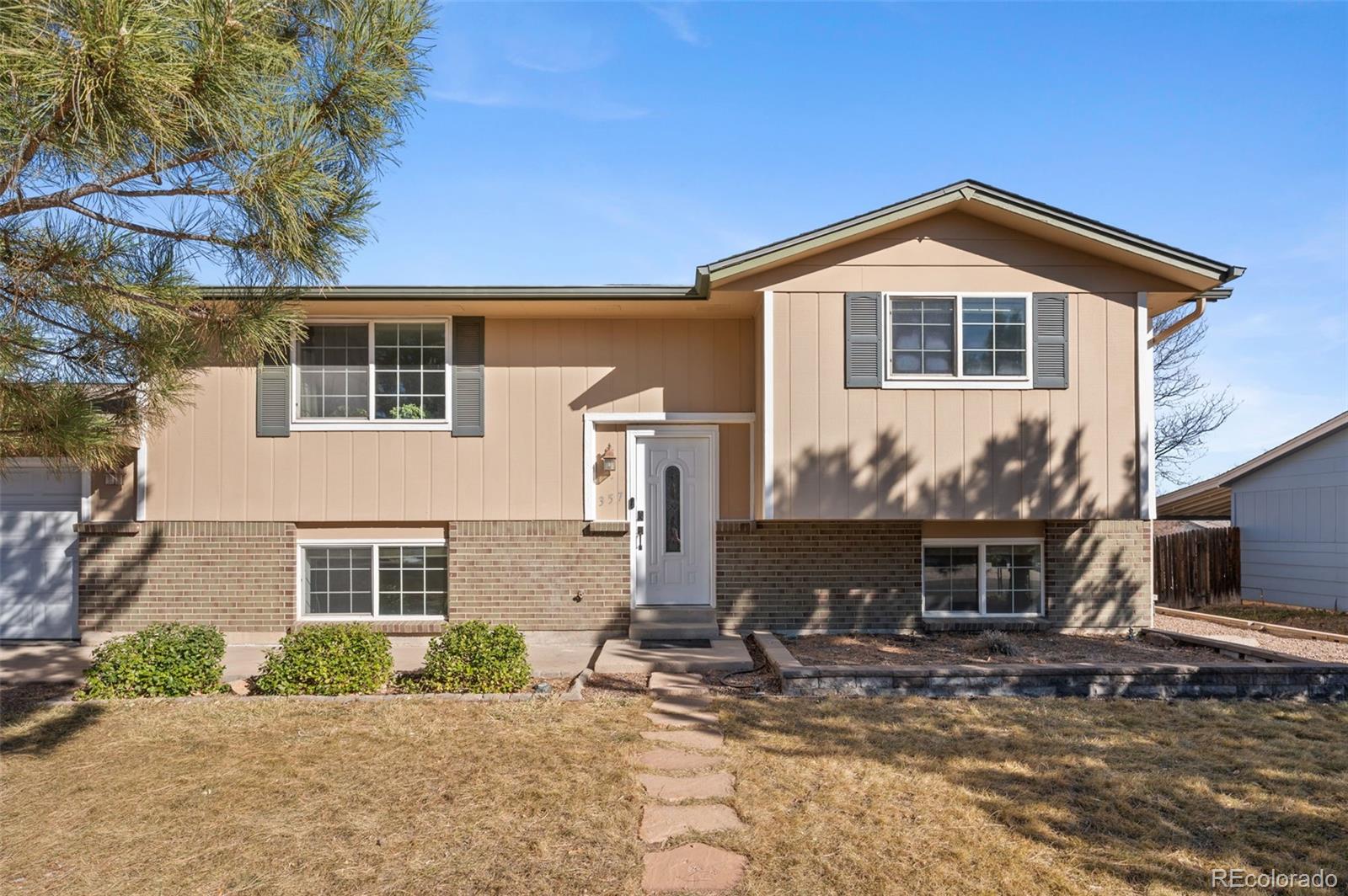 357 Saturn Place Lone Tree, CO 80124 - Photo 39 of 39 a front view of a house with yard