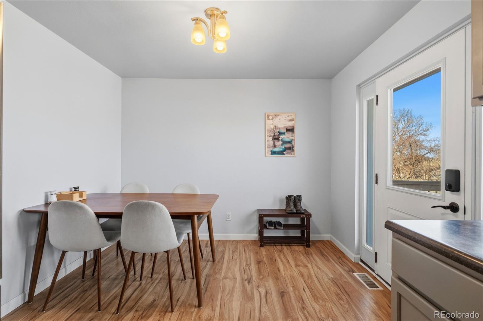 357 Saturn Place Lone Tree, CO 80124 - Photo 7 of 39 a view of a dining room with furniture and wooden floor
