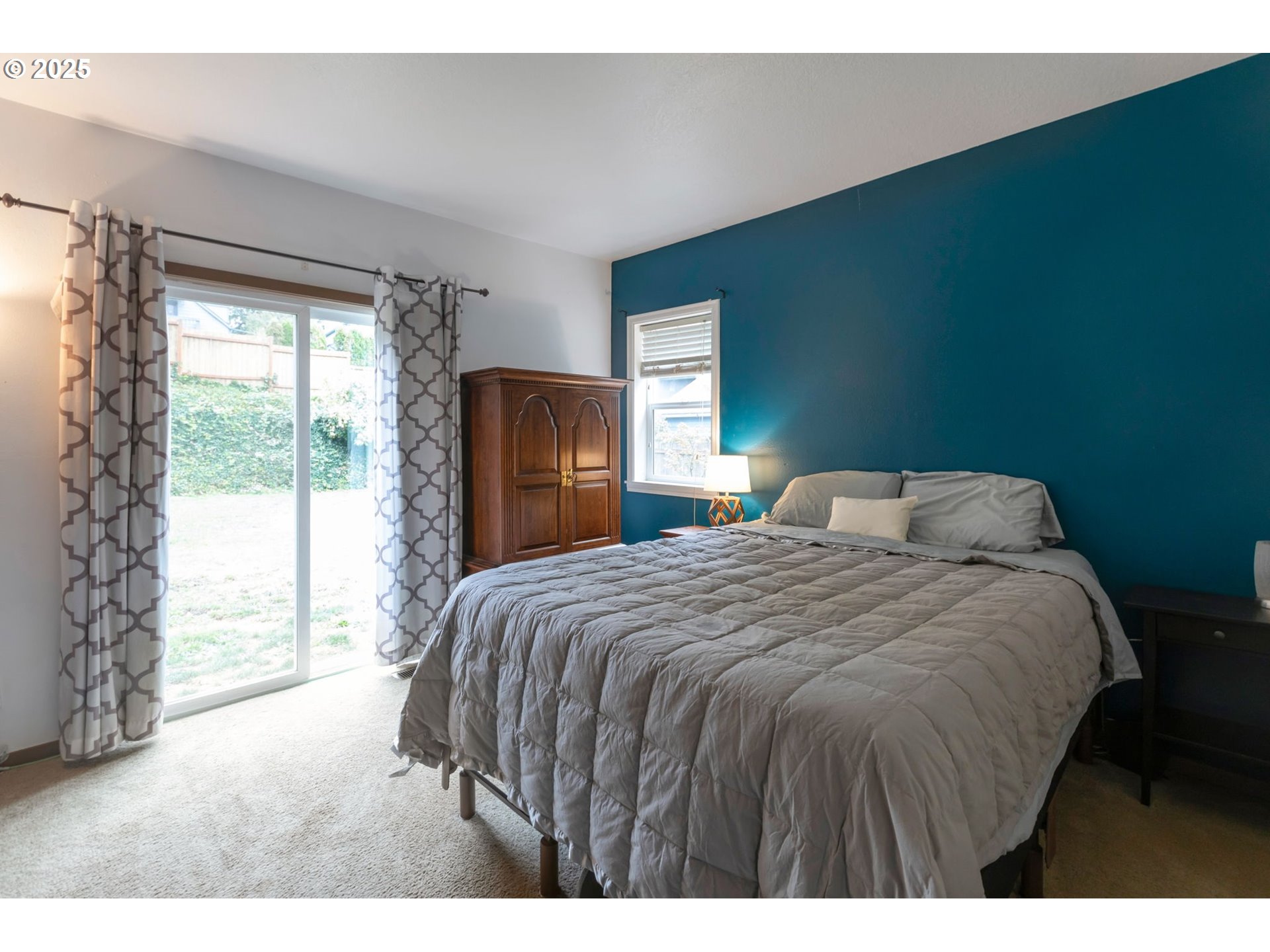 9224 Southwest 26th Avenue Portland, OR 97219 - Photo 14 of 30 a bedroom with a bed and a large window