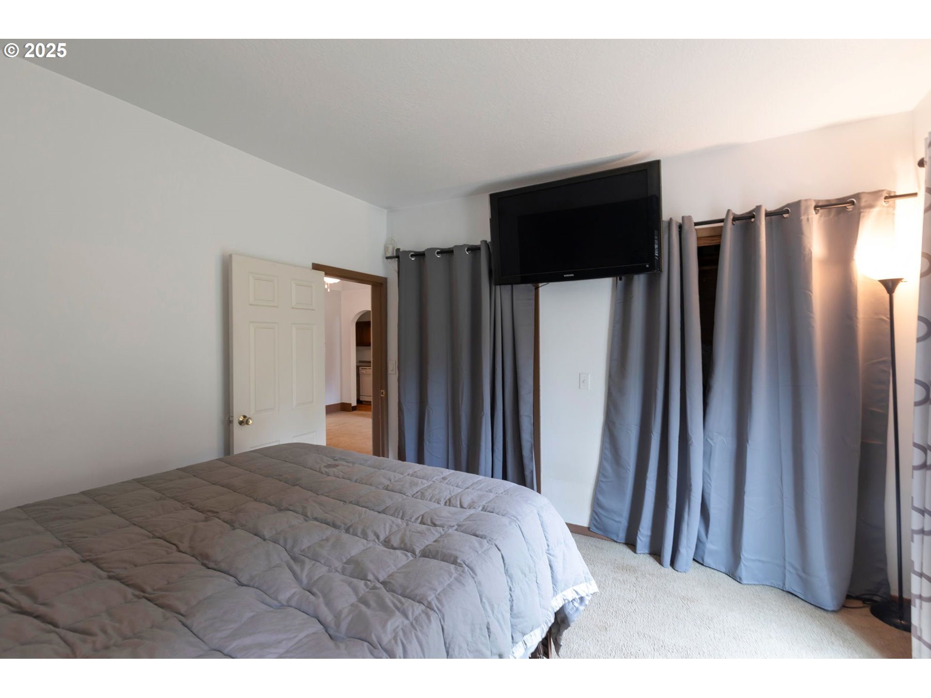 9224 Southwest 26th Avenue Portland, OR 97219 - Photo 15 of 30 a bedroom with a bed and a large mirror