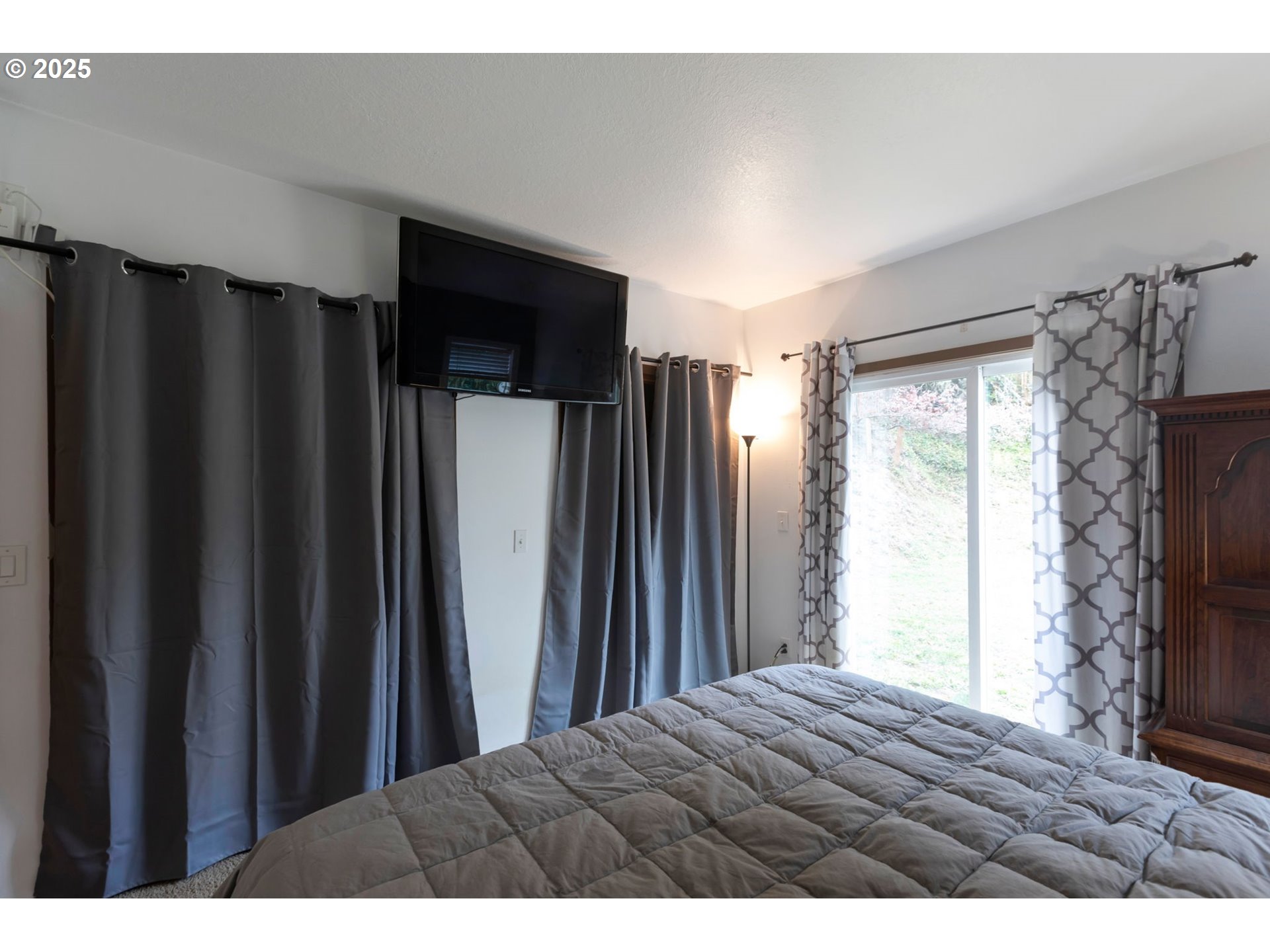 9224 Southwest 26th Avenue Portland, OR 97219 - Photo 16 of 30 a bedroom with a bed and a window