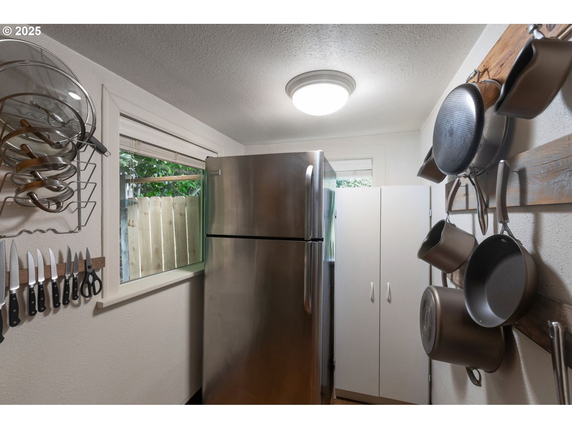 9224 Southwest 26th Avenue Portland, OR 97219 - Photo 19 of 30 a kitchen with stainless steel appliances granite countertop a refrigerator a washer and dryer
