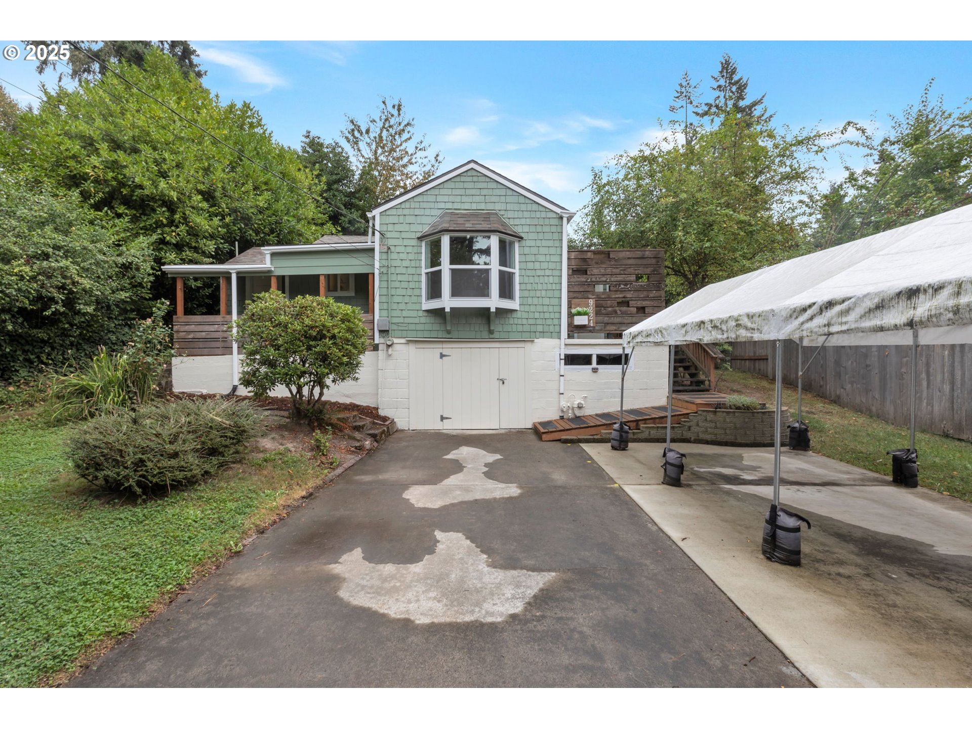 9224 Southwest 26th Avenue Portland, OR 97219 - Photo 2 of 30 a front view of a house with a yard