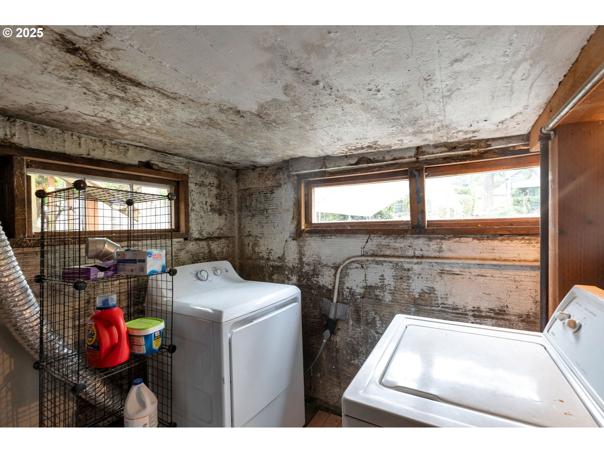9224 Southwest 26th Avenue Portland, OR 97219 - Photo 22 of 30 a utility room with dryer washer and a view of living room