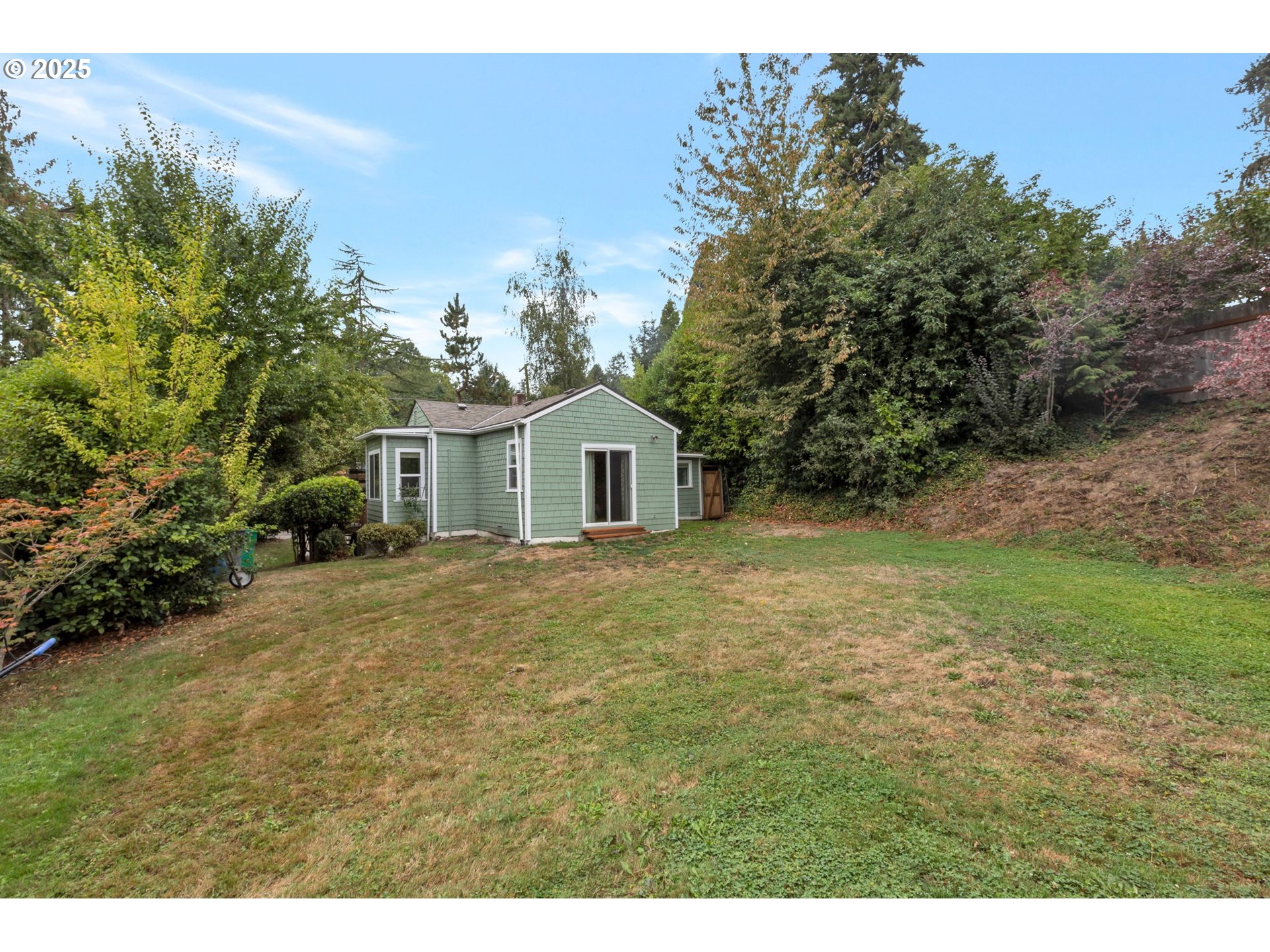 9224 Southwest 26th Avenue Portland, OR 97219 - Photo 28 of 30 a view of a house with backyard and garden