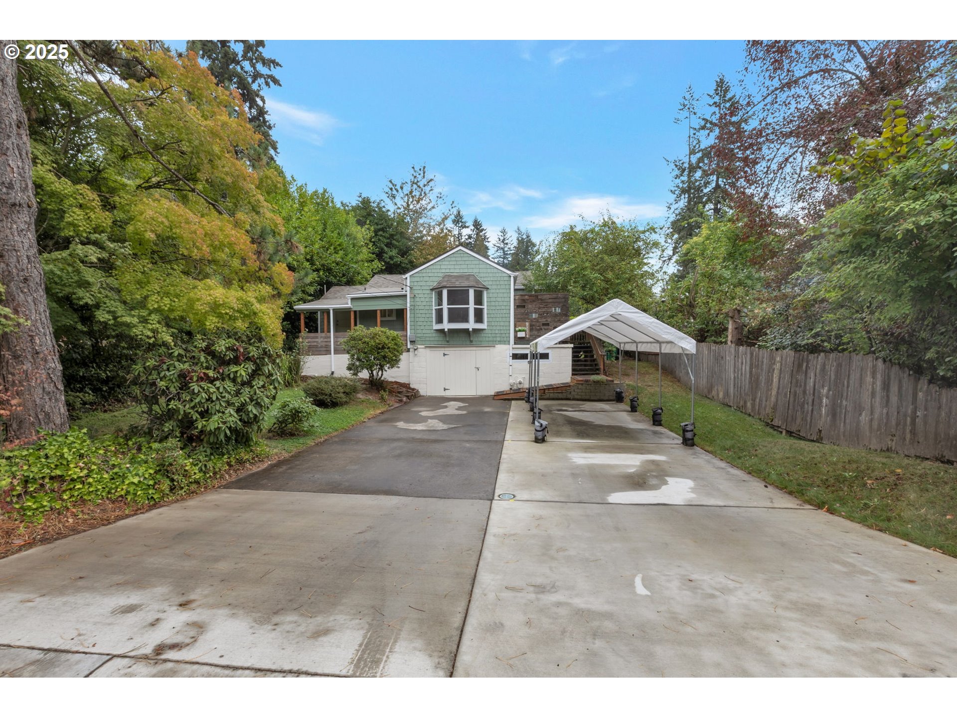 9224 Southwest 26th Avenue Portland, OR 97219 - Photo 29 of 30 a front view of a house with a yard and garage