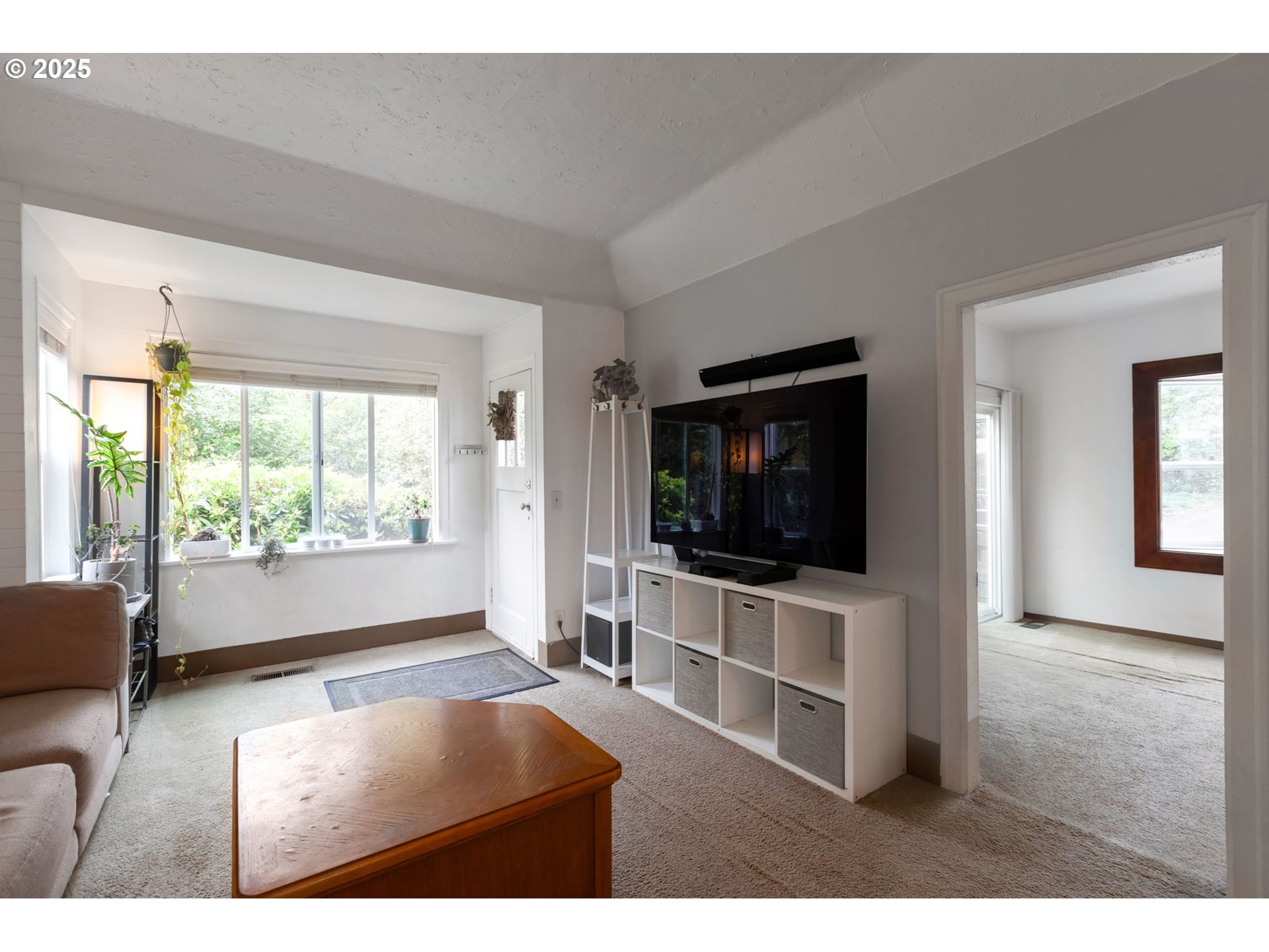 9224 Southwest 26th Avenue Portland, OR 97219 - Photo 7 of 30 a living room with furniture and a flat screen tv