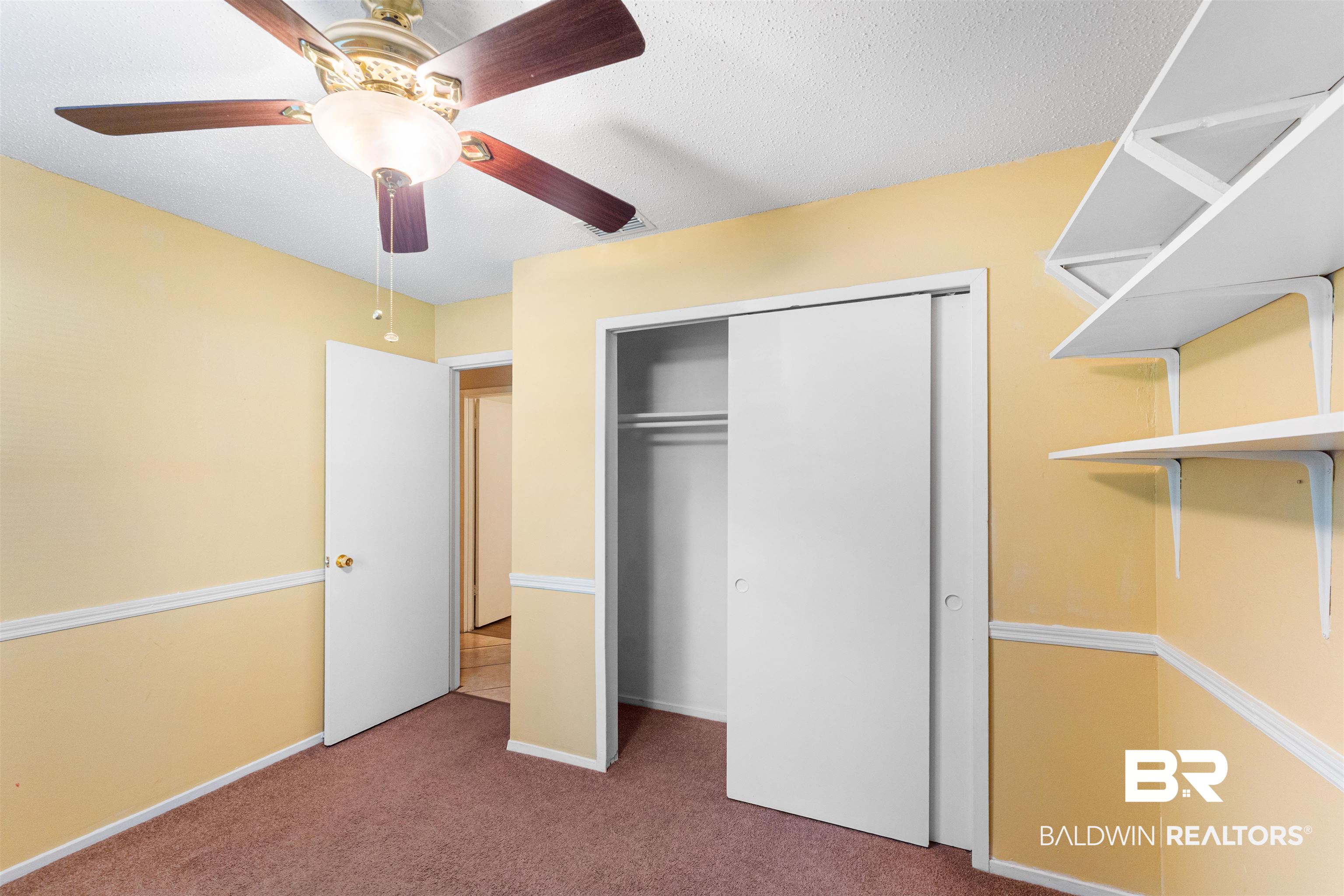 5551 Springer Court Theodore, AL 36582 - Photo 31 of 37 Unfurnished bedroom with carpet, ceiling fan, a textured ceiling, and a closet