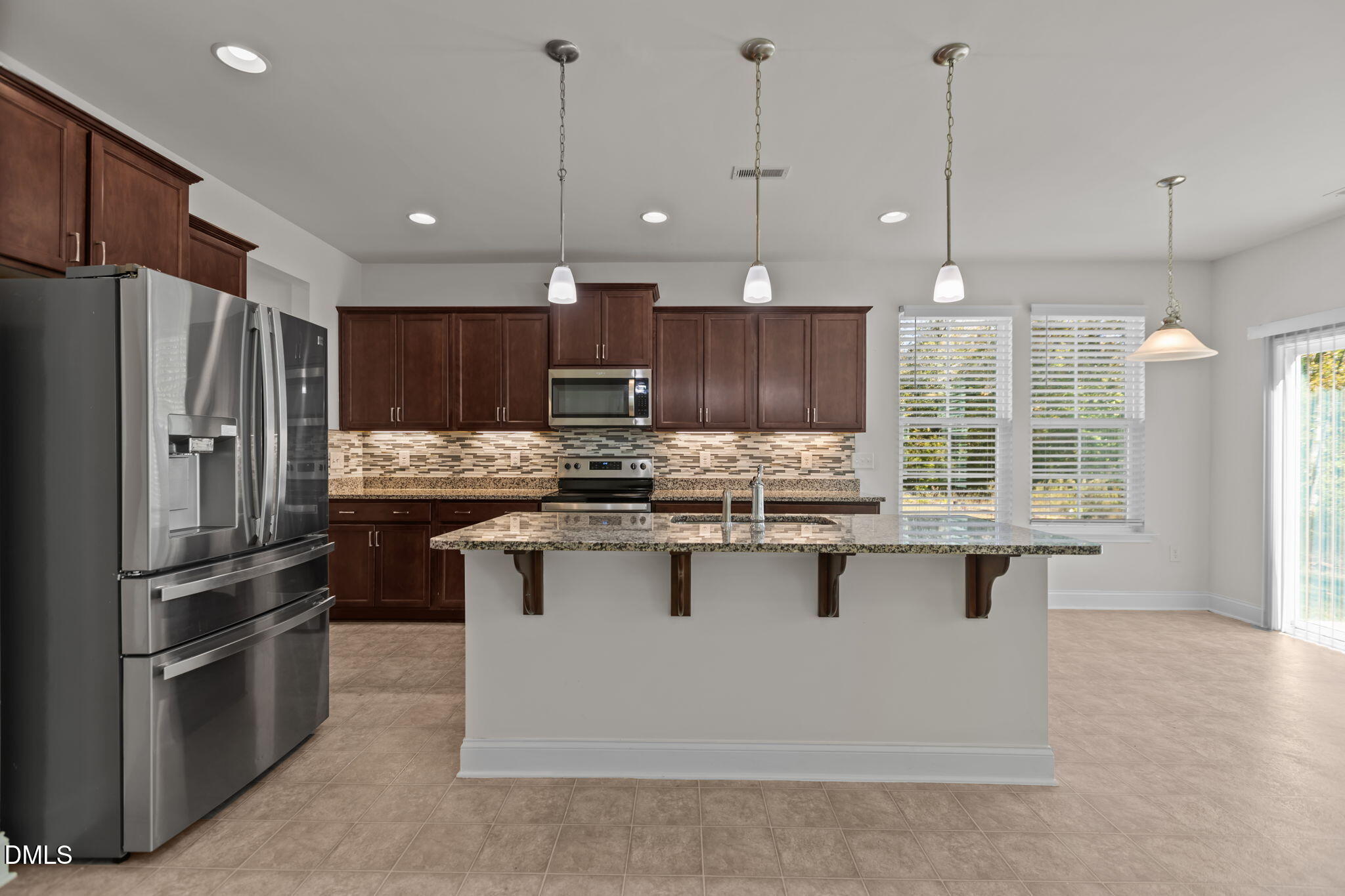 354 Dando Street Garner, NC 27529 - Photo 13 of 61 a kitchen with kitchen island a sink stainless steel appliances and cabinets