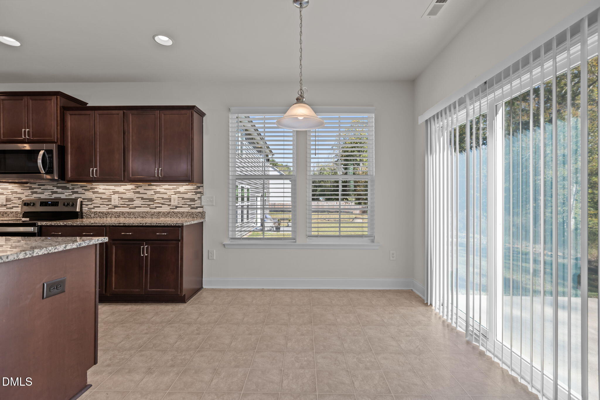 354 Dando Street Garner, NC 27529 - Photo 14 of 61 a kitchen with stainless steel appliances granite countertop a stove a sink dishwasher a refrigerator and a microwave oven