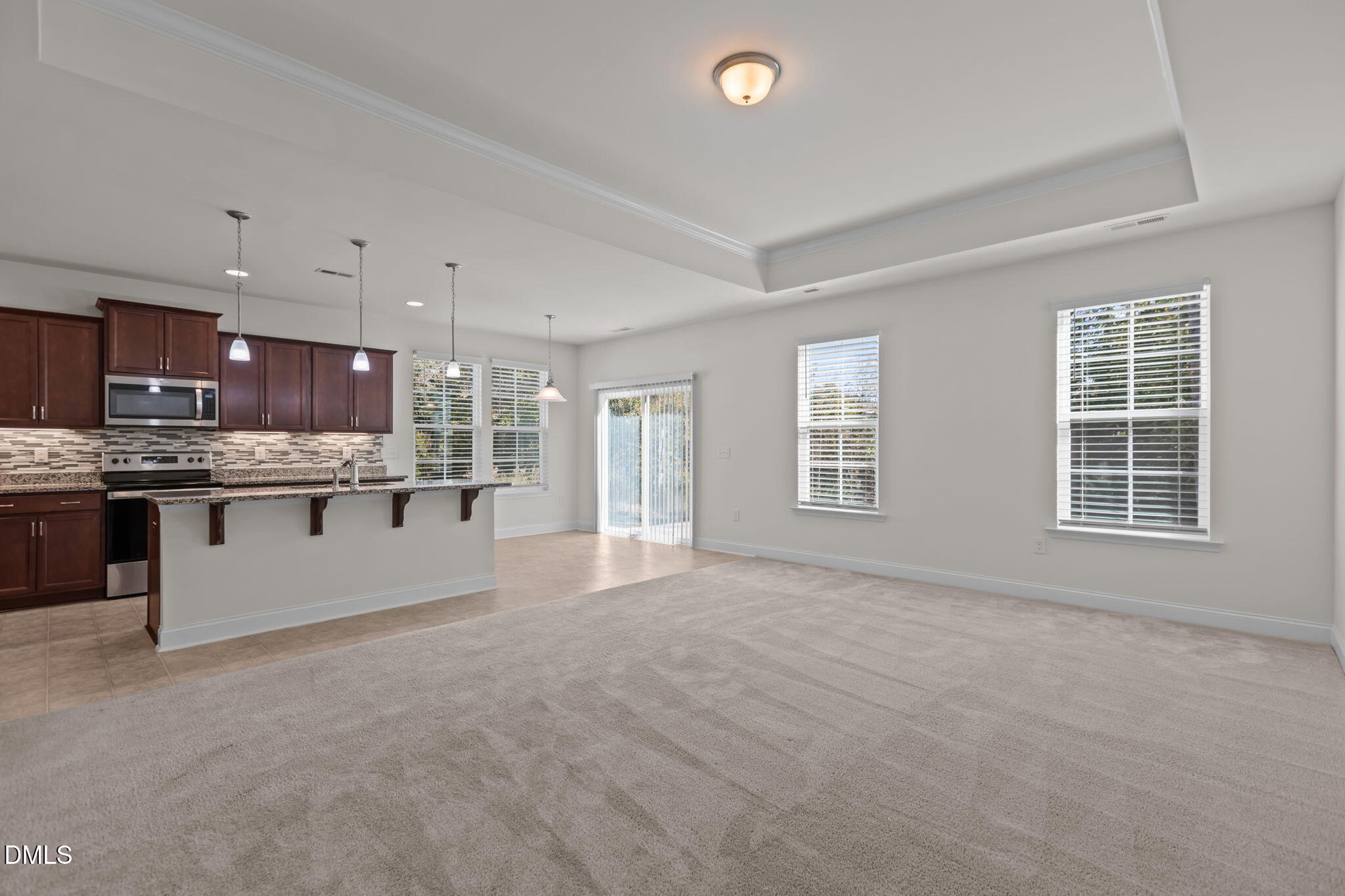 354 Dando Street Garner, NC 27529 - Photo 18 of 61 a large kitchen with stainless steel appliances granite countertop a large counter top and a stove