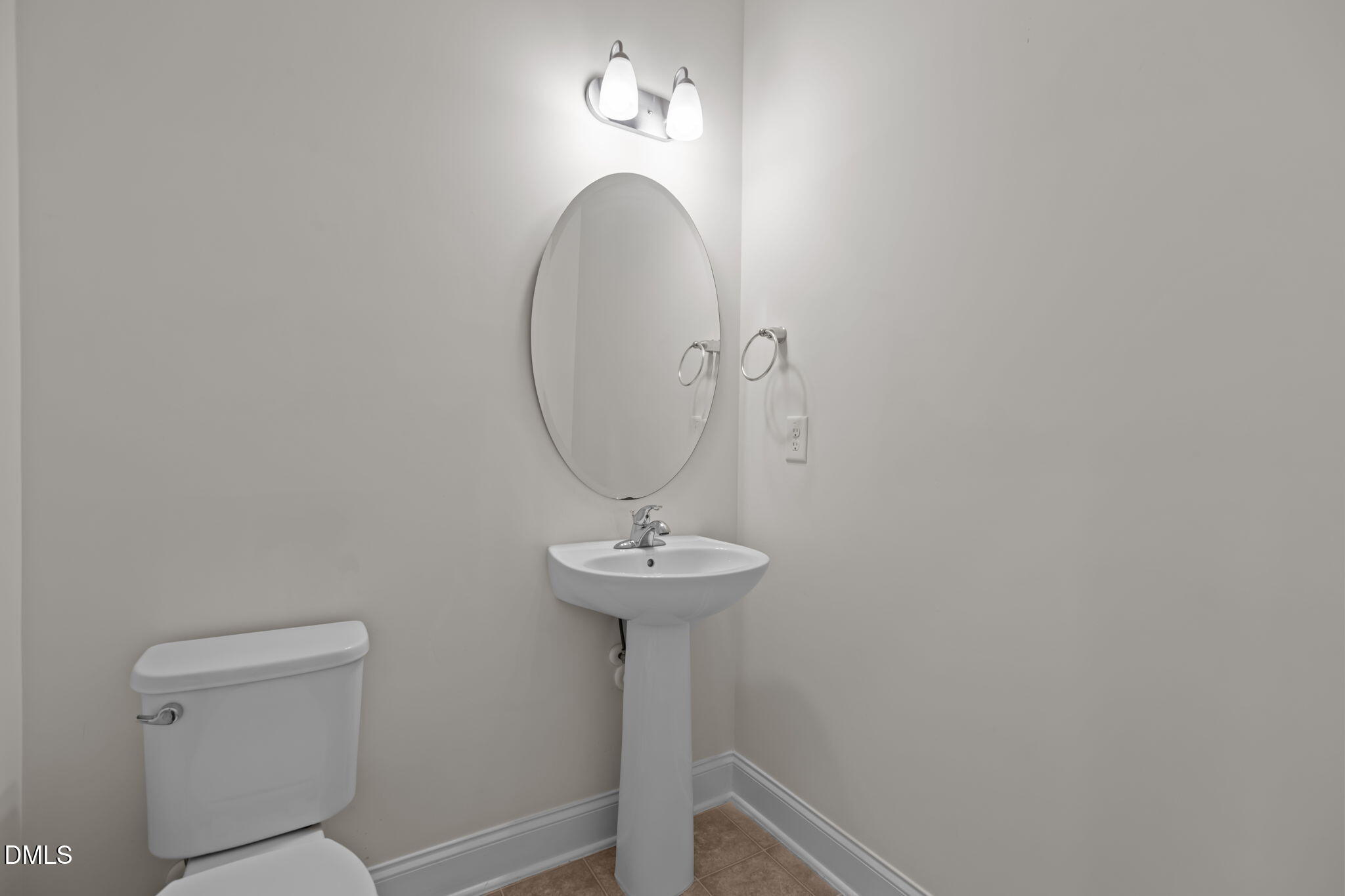 354 Dando Street Garner, NC 27529 - Photo 25 of 61 a bathroom with a toilet a sink and mirror