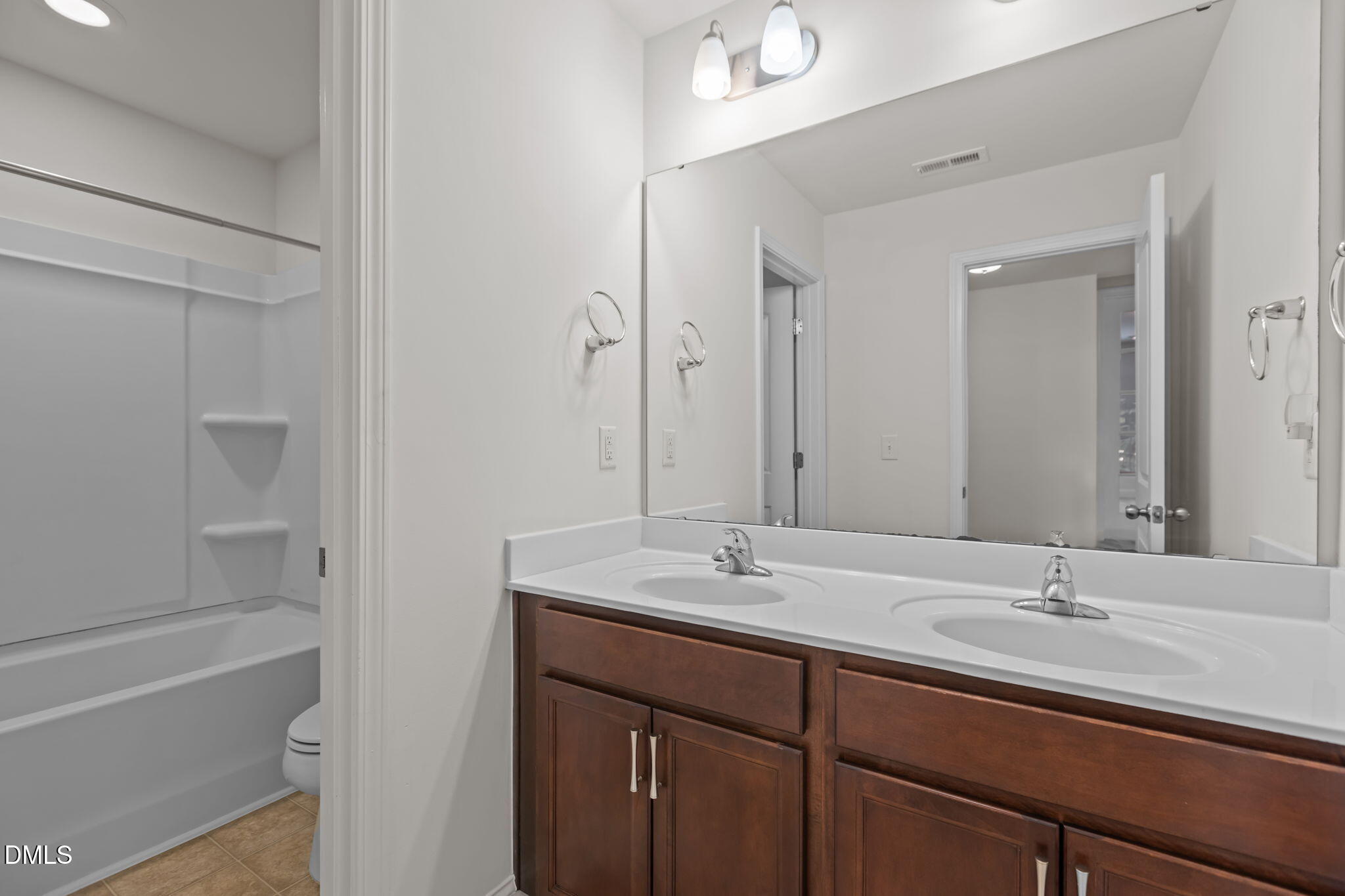 354 Dando Street Garner, NC 27529 - Photo 33 of 61 a bathroom with a sink double vanity granite tub shower and a mirror