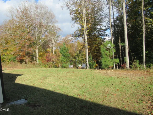 a view of a patio with table and chairs and potted plants