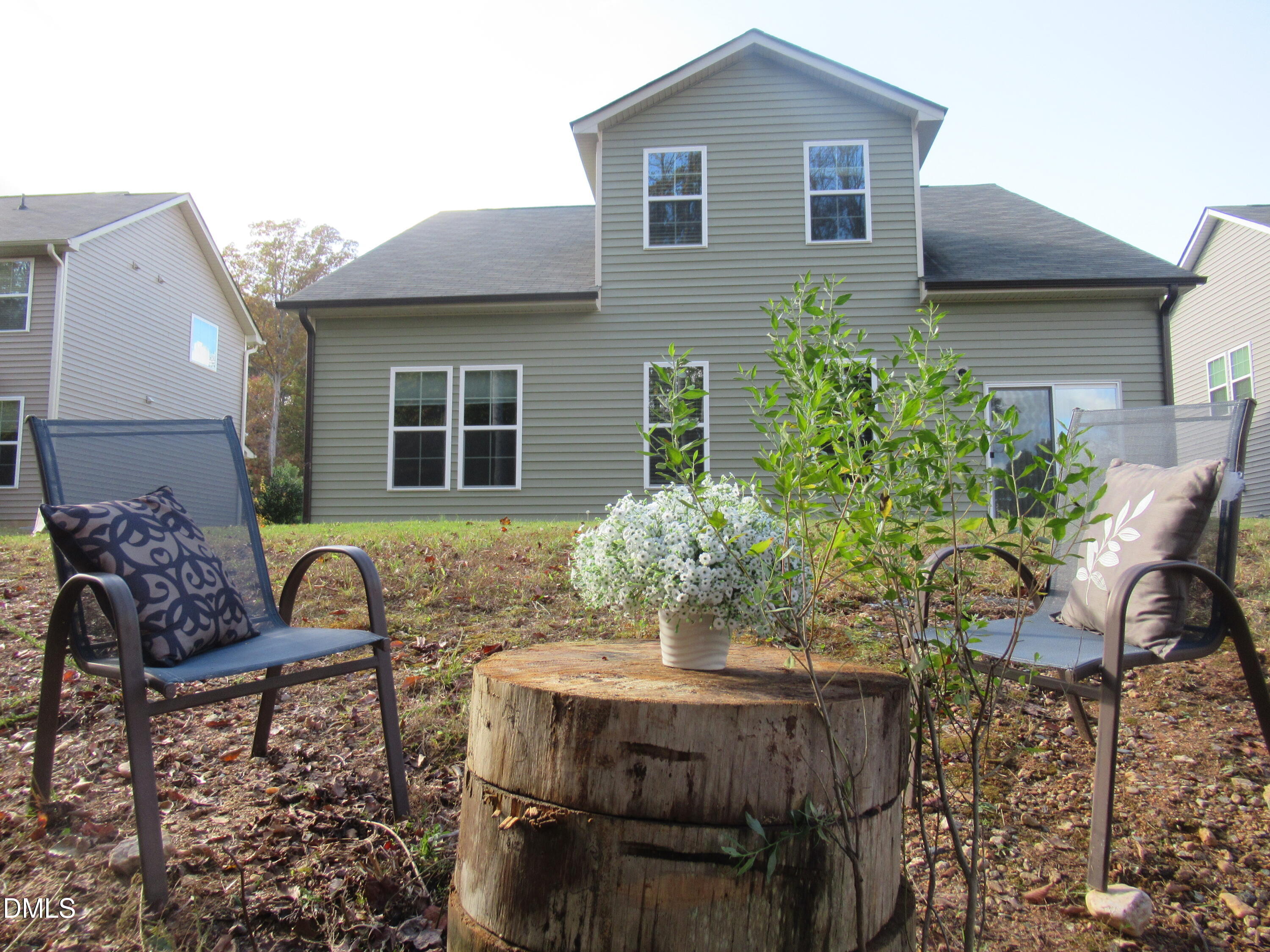 354 Dando Street Garner, NC 27529 - Photo 48 of 61 a view of a patio with table and chairs and potted plants