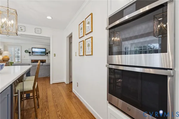 a kitchen with granite countertop white cabinets and appliances
