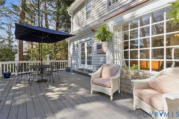 a view of a chair and table on the deck