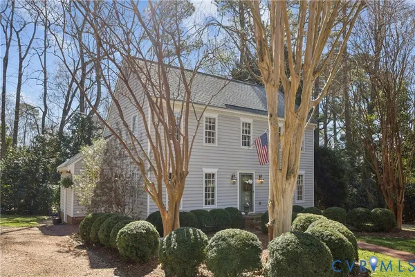 a brick house with trees in front of it