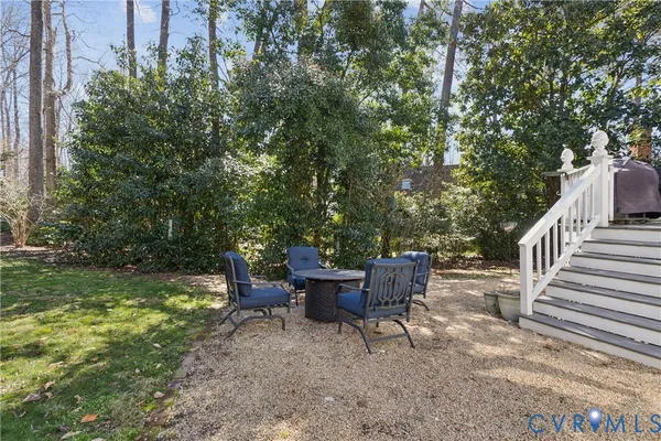 a view of backyard with seating space and trees