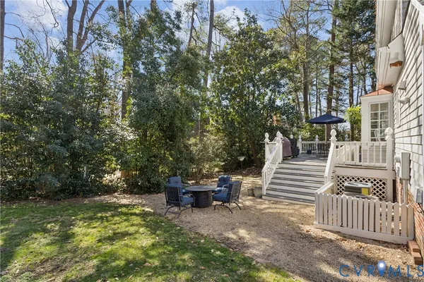a view of backyard with deck and garden