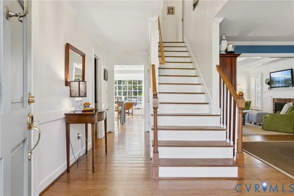 a view of entryway and hall with wooden floor