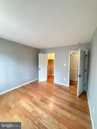 a view of an empty room and wooden floor