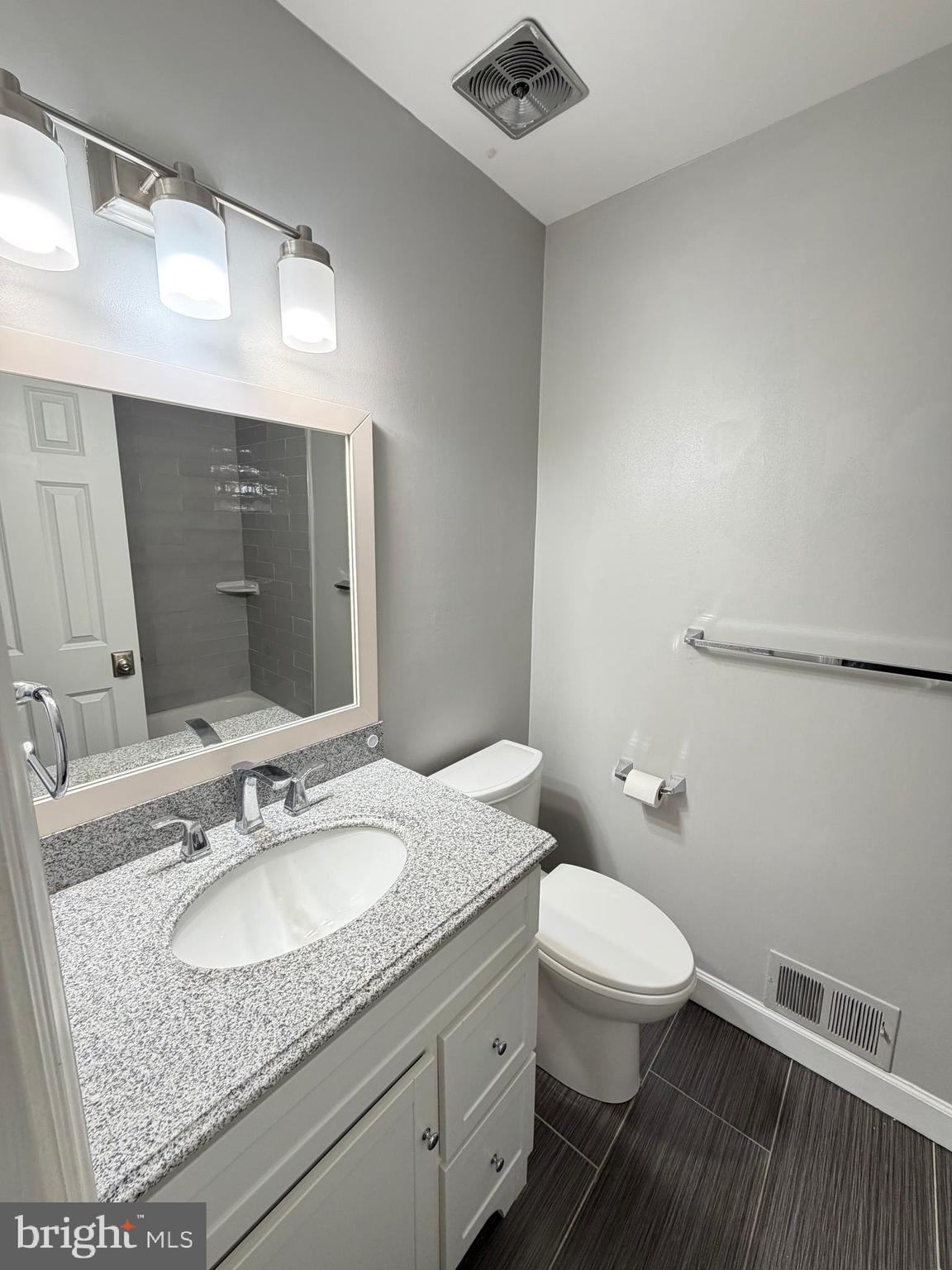 12629 English Orchard Court Silver Spring, MD 20906 - Photo 18 of 31 a bathroom with a granite countertop sink a toilet and a mirror