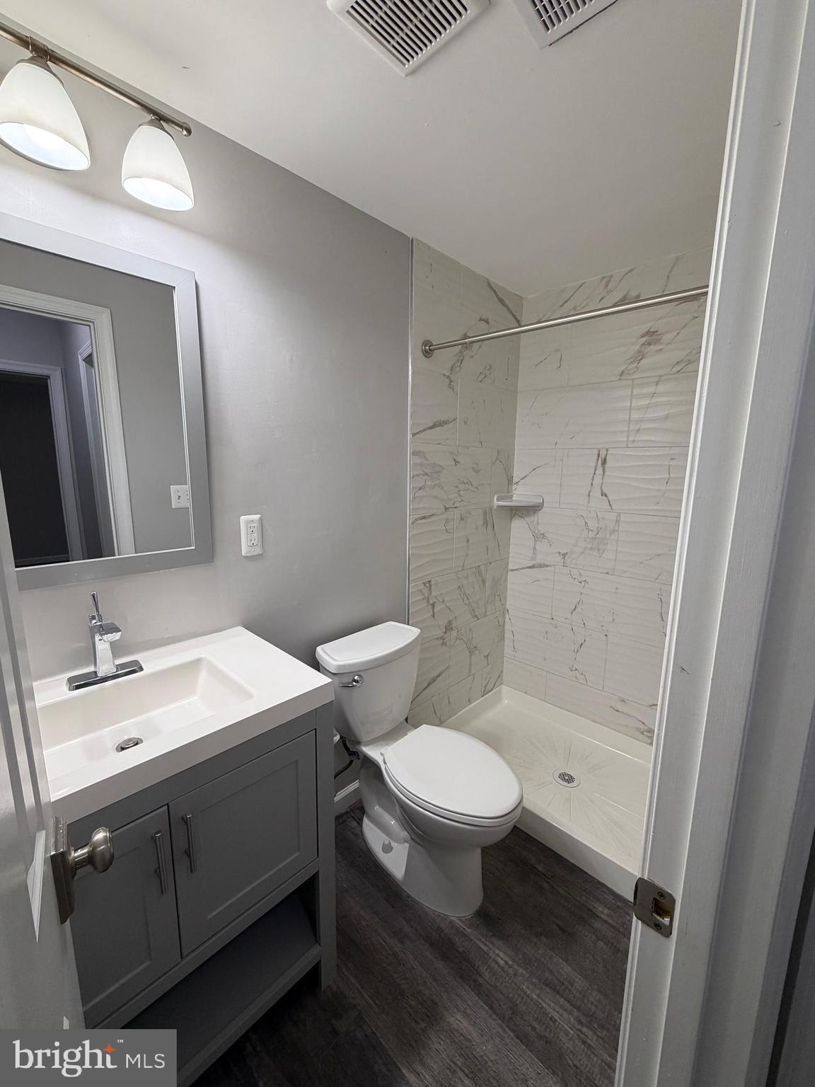 12629 English Orchard Court Silver Spring, MD 20906 - Photo 22 of 31 a bathroom with a sink a toilet a mirror and shower