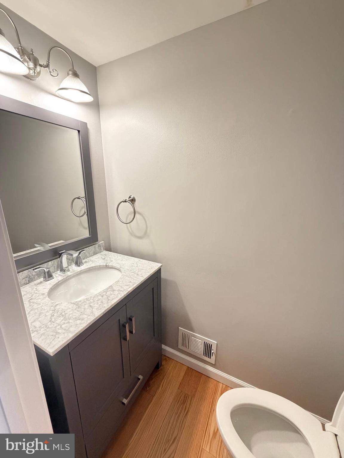 12629 English Orchard Court Silver Spring, MD 20906 - Photo 7 of 31 a bathroom with a granite countertop sink vanity mirror and toilet