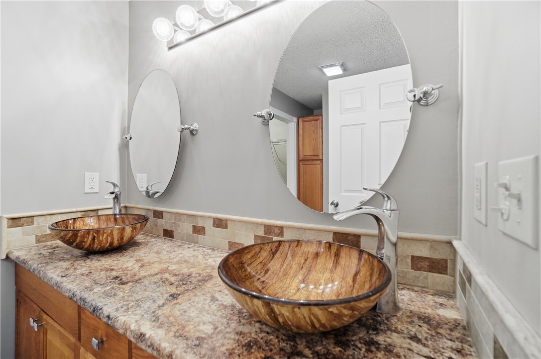 1208 Jarva Lane Springboro, OH 45066 - Photo 35 of 75 This primary bathroom offers dual vessel sinks, modern fixtures, and ample counter space for daily routines.