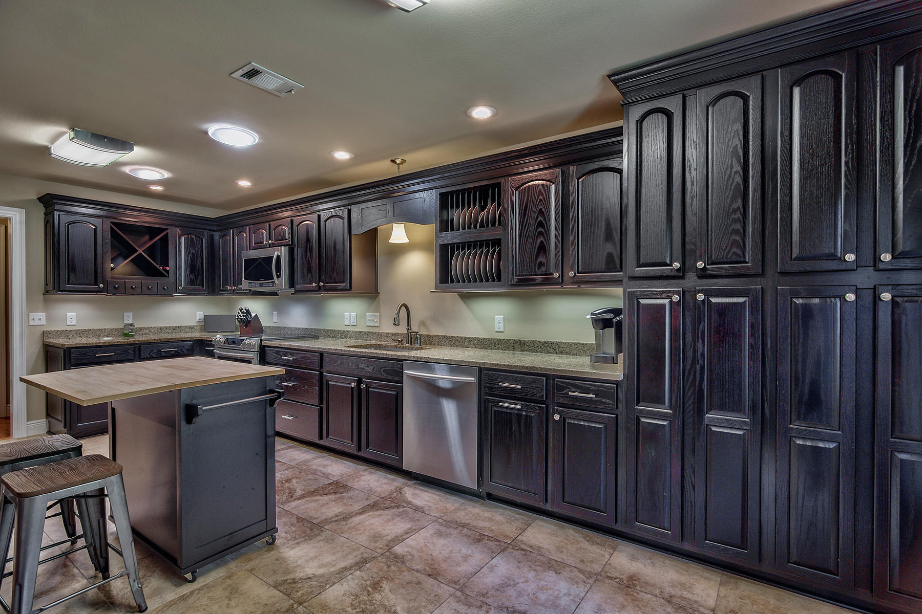 2884 Silverhill Road Crestview, FL 32536 - Photo 1 of 16 a kitchen with kitchen island granite countertop wooden cabinets stainless steel appliances a sink and a counter top space