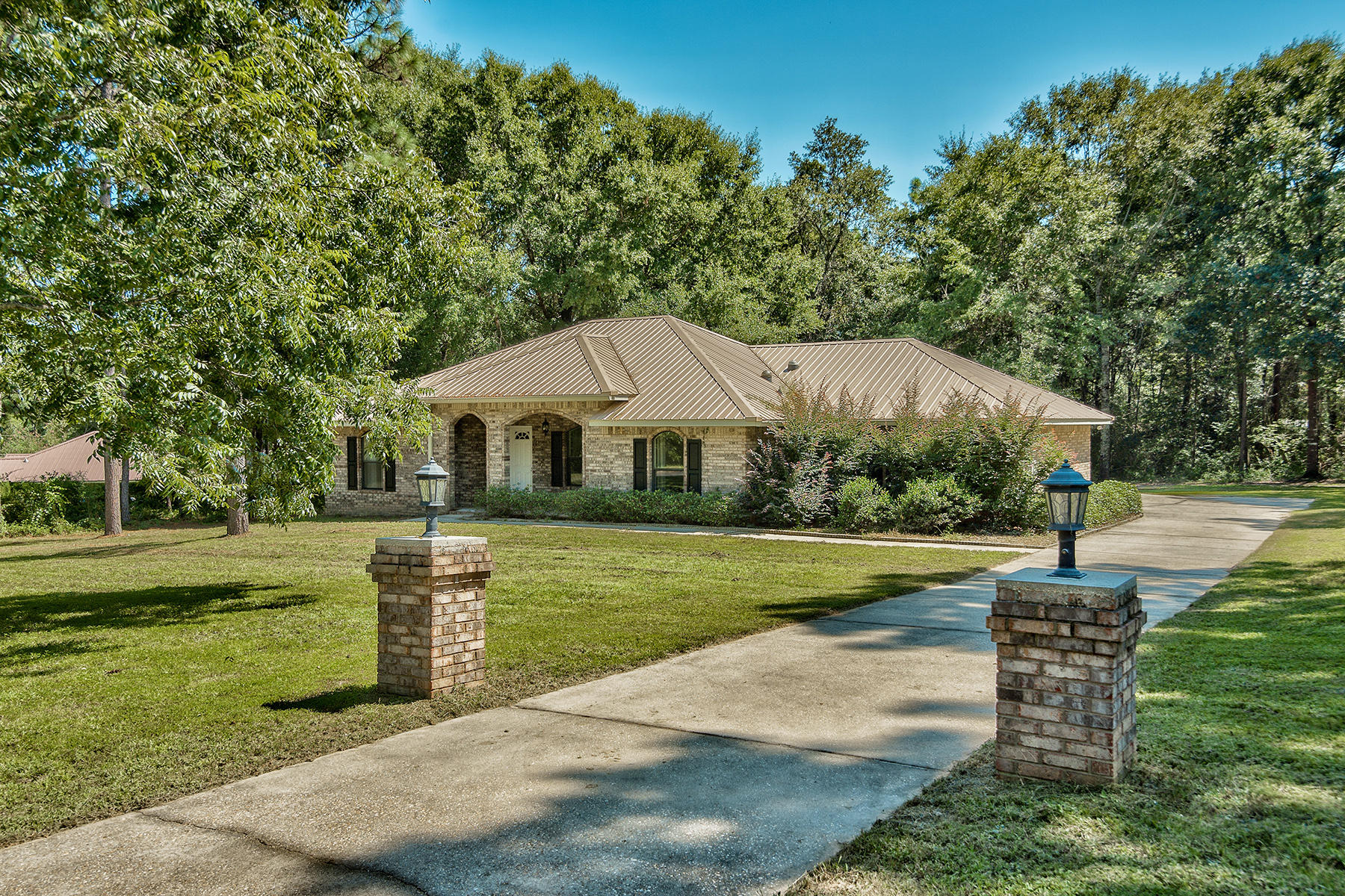 2884 Silverhill Road Crestview, FL 32536 - Photo 2 of 16 a front view of a house with garden