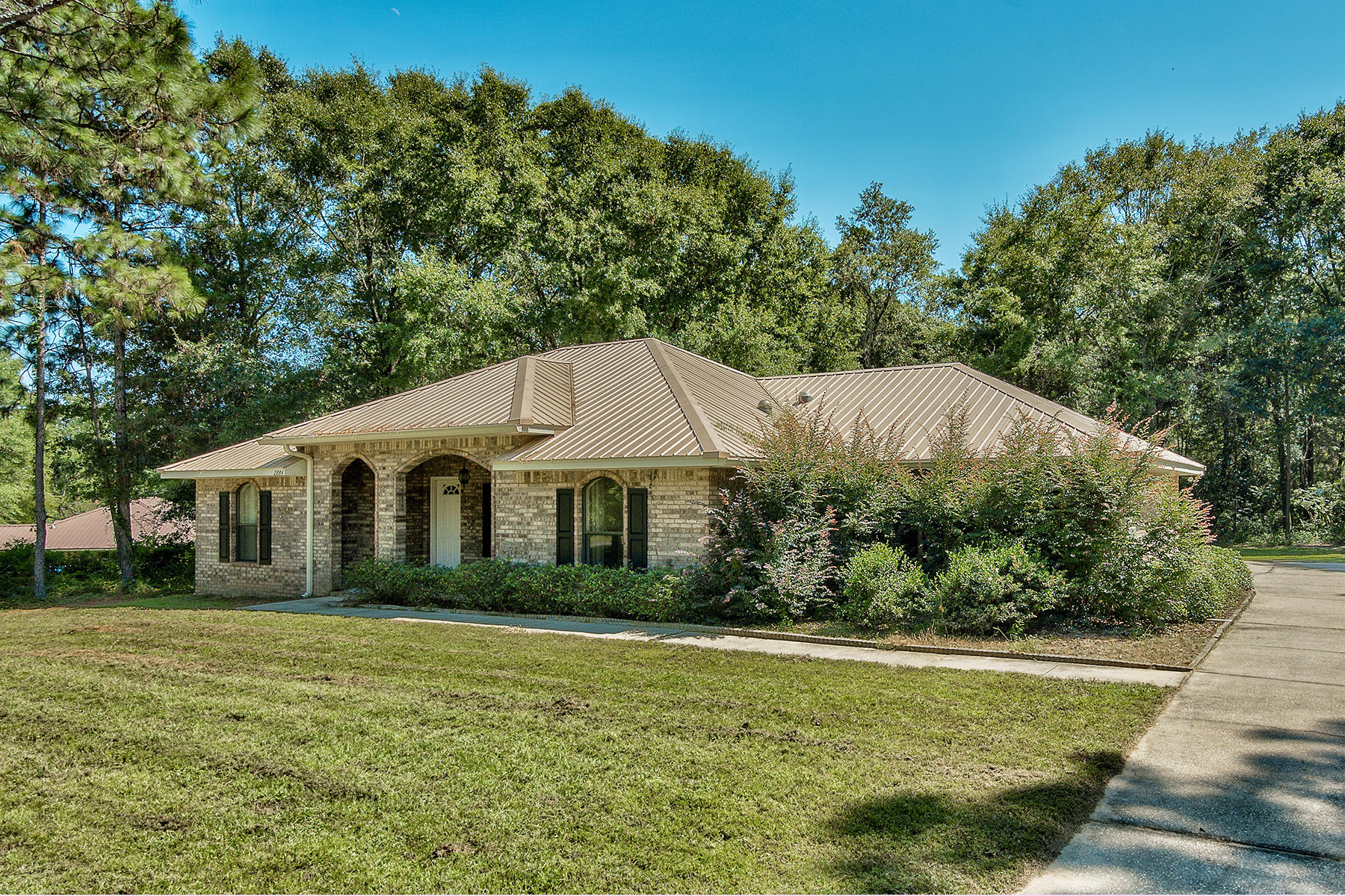 2884 Silverhill Road Crestview, FL 32536 - Photo 3 of 16 a front view of a house with a garden