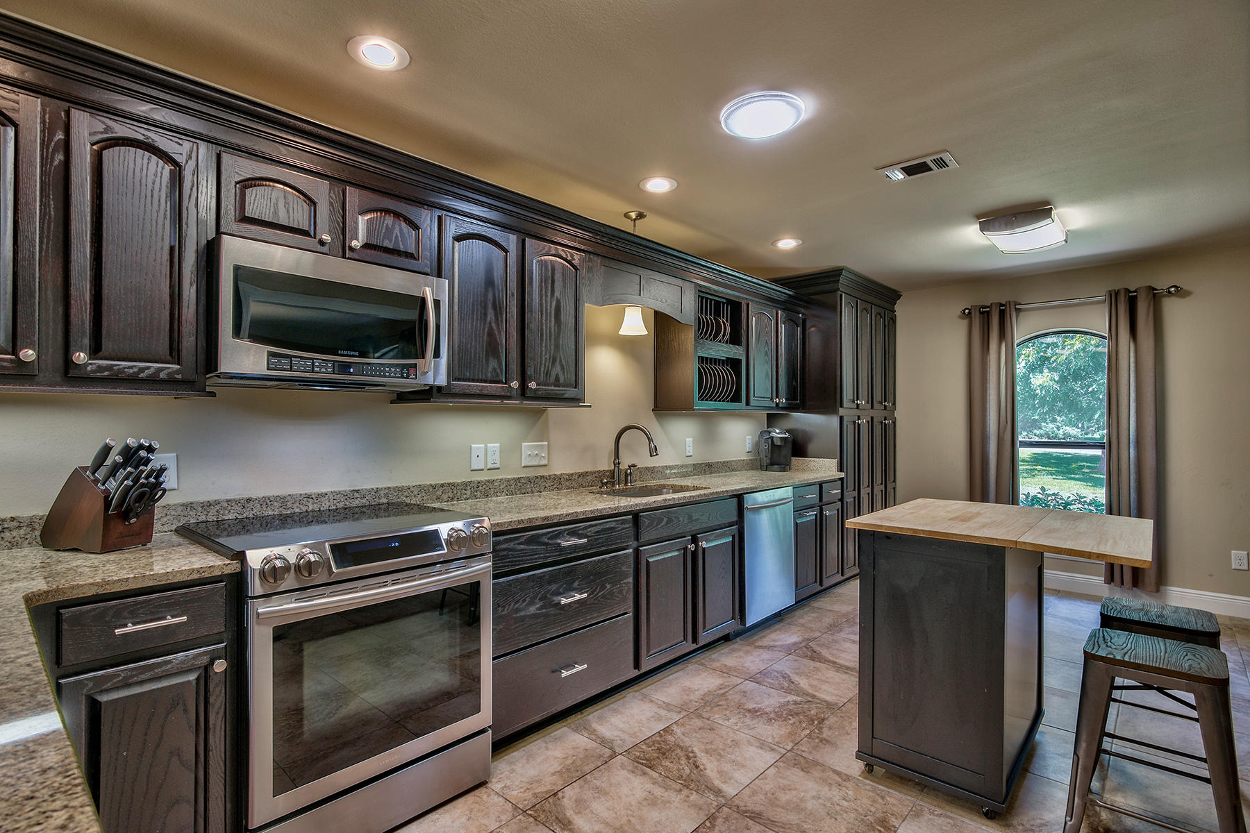 2884 Silverhill Road Crestview, FL 32536 - Photo 5 of 16 a kitchen with stainless steel appliances granite countertop wooden cabinets a stove top oven a sink and dishwasher