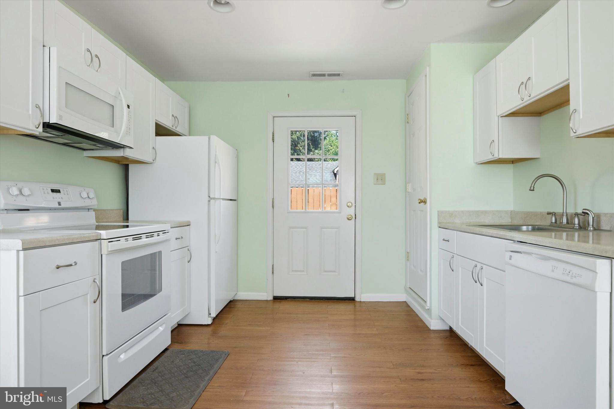 1265 Old York Road Warminster, PA 18974 - Photo 28 of 35 a kitchen with white cabinets and white appliances
