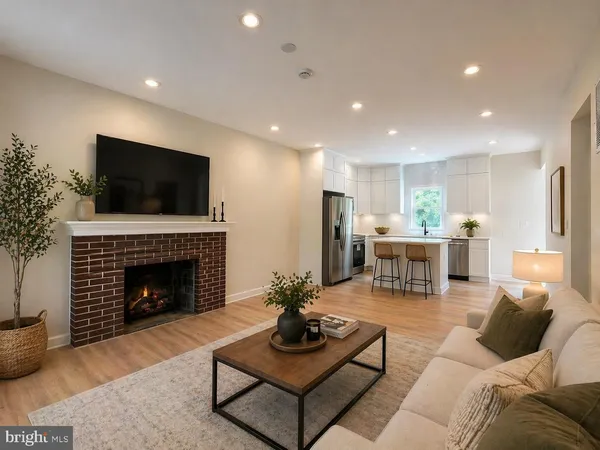 a living room with furniture a fireplace and a flat screen tv