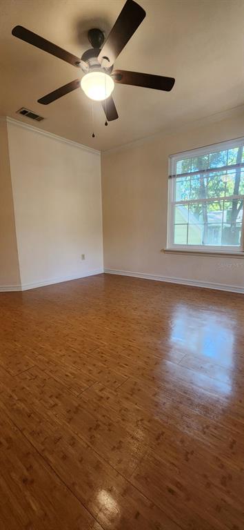 413 Northwest 48th Boulevard Gainesville, FL 32607 - Photo 12 of 21 an empty room with wooden floor fan and windows