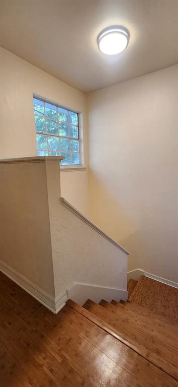 413 Northwest 48th Boulevard Gainesville, FL 32607 - Photo 19 of 21 an empty room with wooden floor and windows