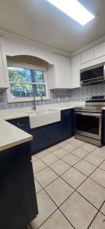 413 Northwest 48th Boulevard Gainesville, FL 32607 - Photo 7 of 21 a kitchen with stainless steel appliances a sink and a stove