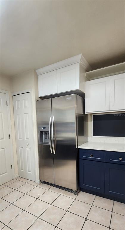 413 Northwest 48th Boulevard Gainesville, FL 32607 - Photo 8 of 21 a kitchen with a refrigerator and cabinets