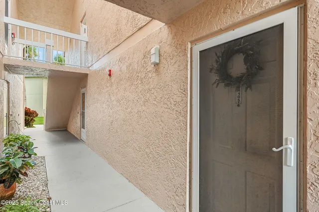 a kitchen with stainless steel appliances a sink a refrigerator and a counter top space