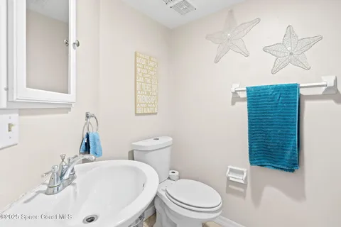 a view of a balcony with furniture and a potted plant