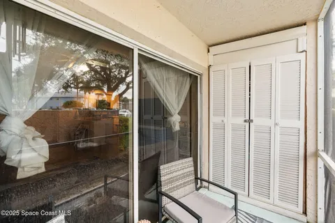 a view of a chairs in backyard of a house