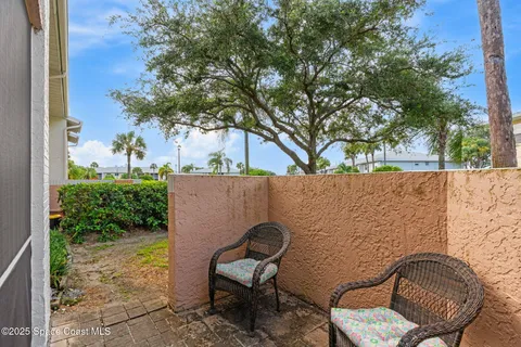 a balcony with table and chairs