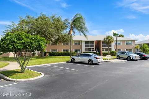 a view of a parked cars in front of a house